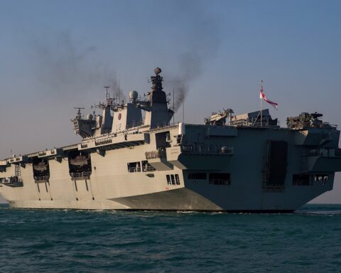 HMS Ocean amphibious assault ship flying Royal Navy White Ensign on deployment to the Gulf as part of the UK Joint Expeditionary Force Maritime task group