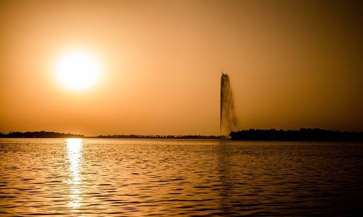 King Fahd Fountain in Jeddah at sunset with golden light reflecting on the Red Sea