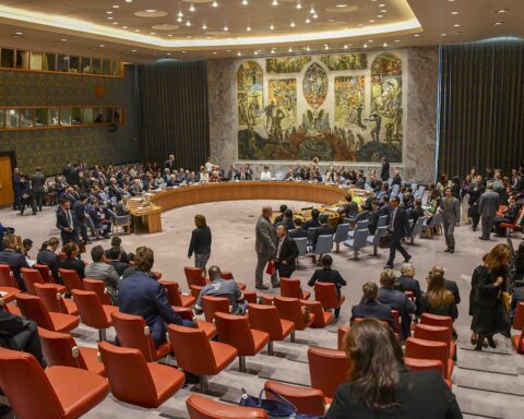 UN Security Council chamber with delegations seated around the horseshoe-shaped table during a formal session at UN headquarters in New York