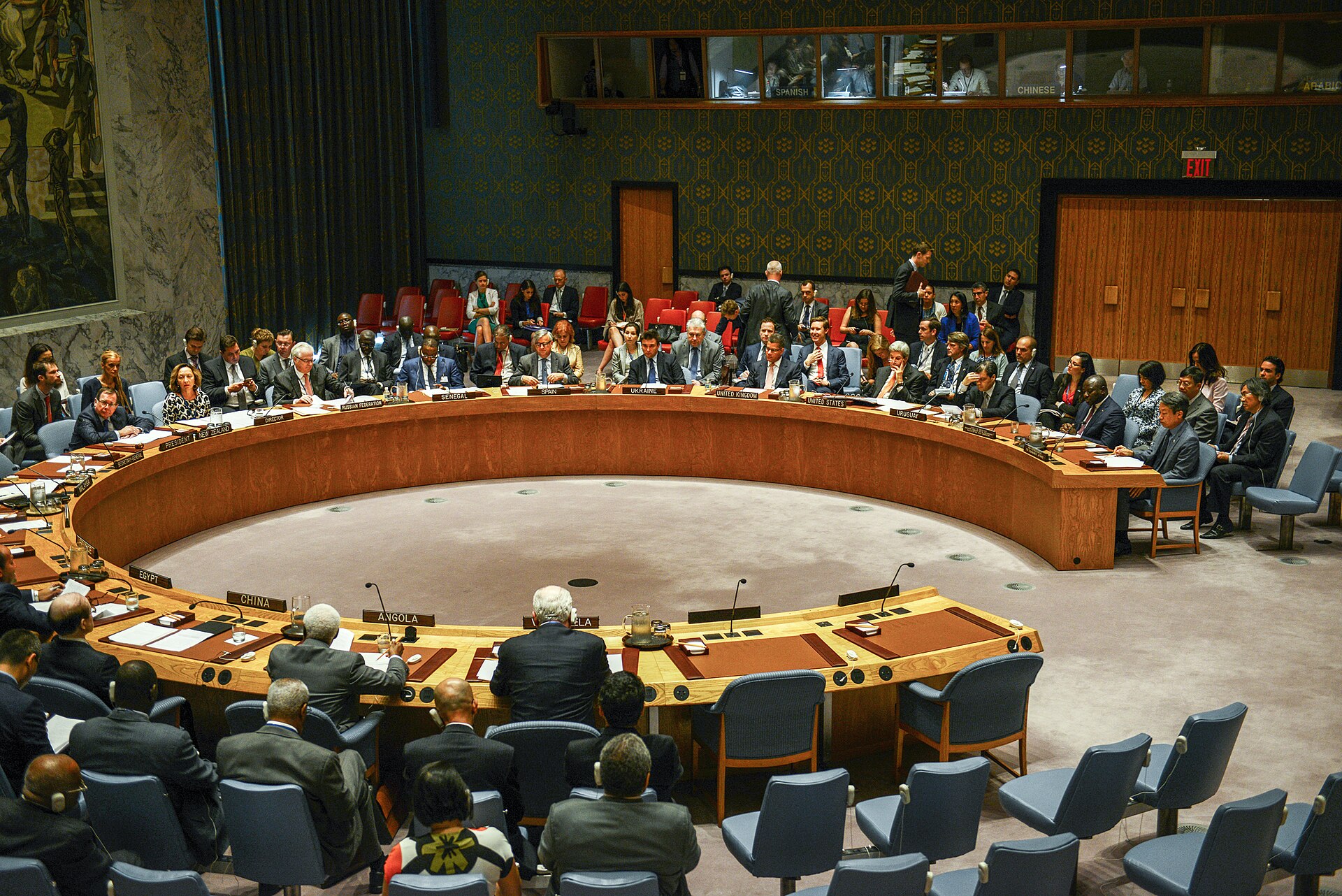 UN Security Council chamber during vote with all 15 member delegations at the horseshoe table, China nameplate visible in foreground