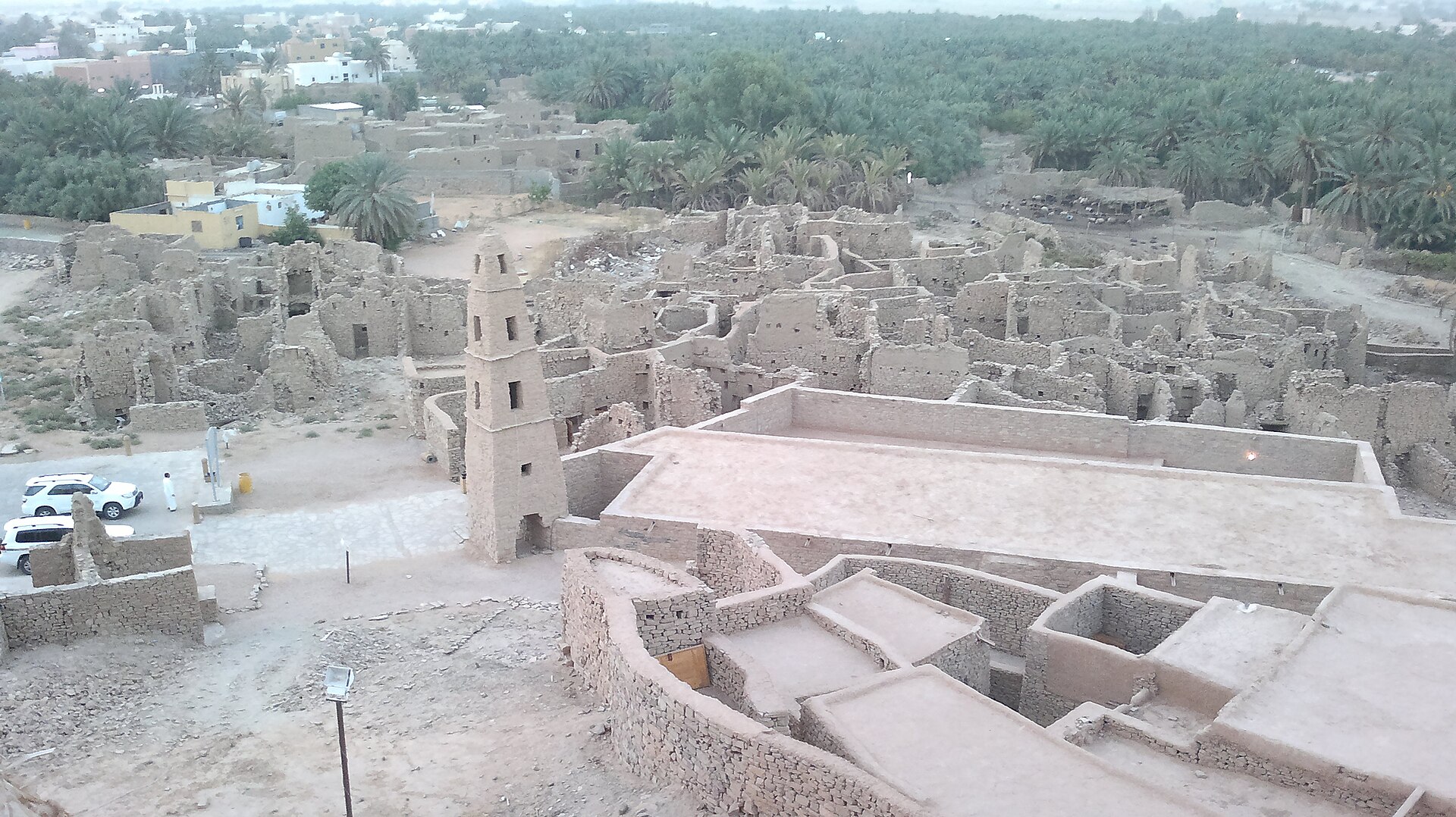 View from Marid Castle over the Omar ibn al-Khattab Mosque and the ruined old quarter of Dumat al-Jandal, with palm groves in the background