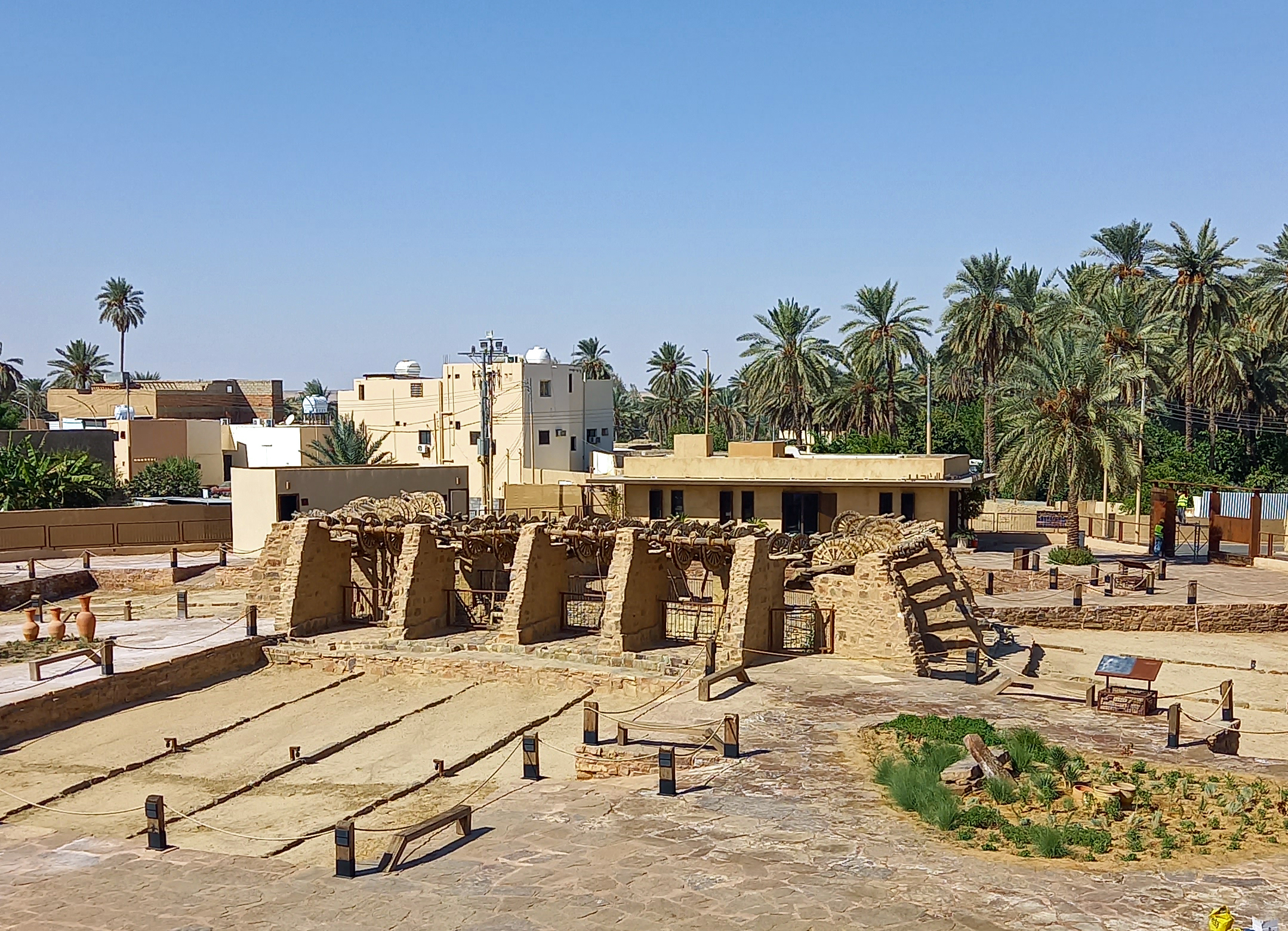 Bir Haddaj ancient well in Tayma, Saudi Arabia, with surrounding palm gardens
