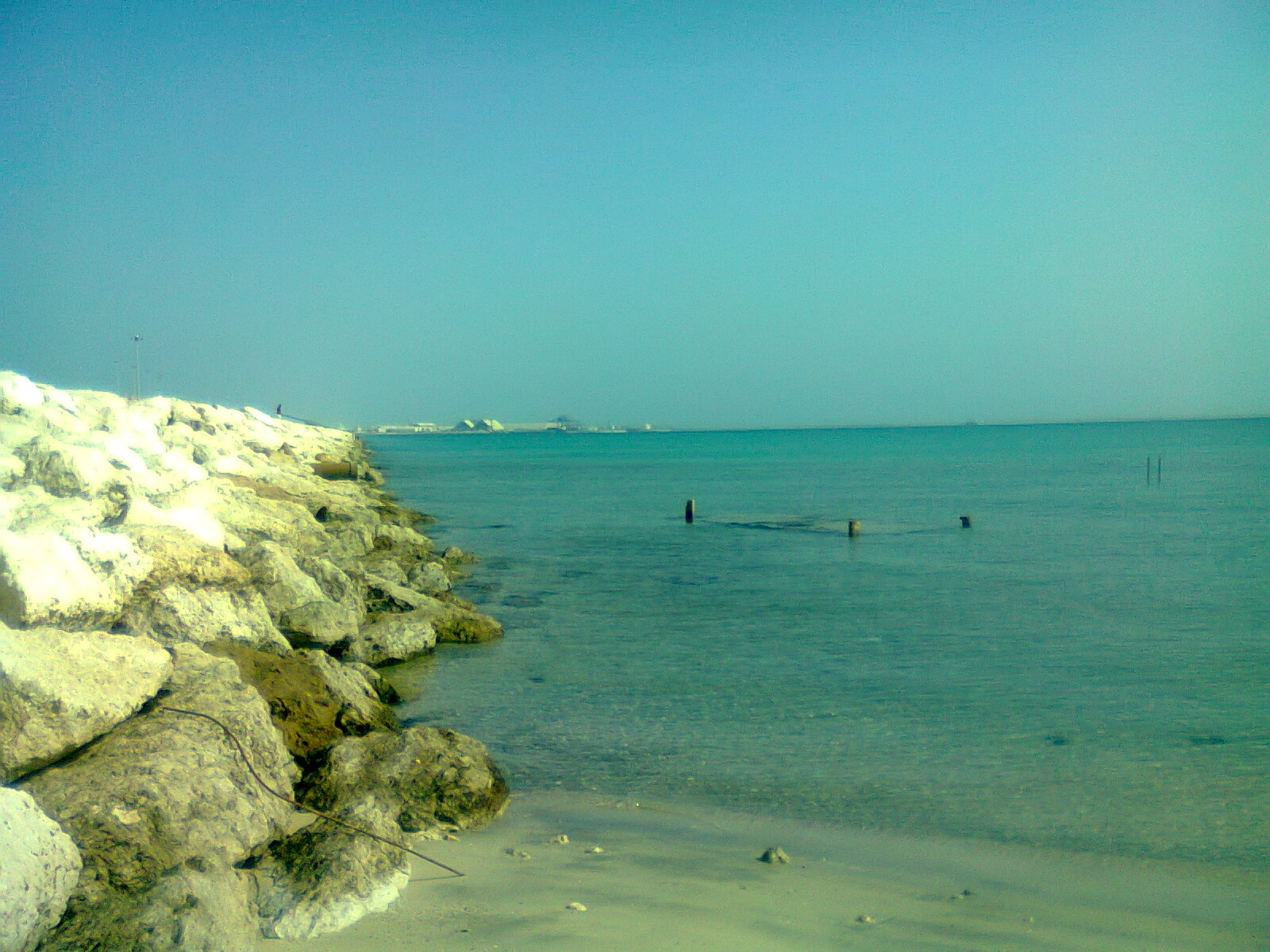 The Arabian Gulf coastline at Jubail, Saudi Arabia, showing rocky outcrops and turquoise waters stretching toward the horizon