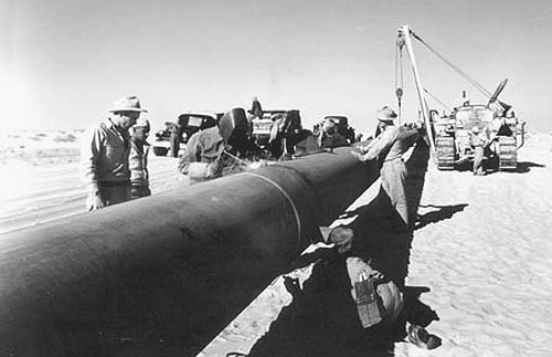 Workers welding sections of the Trans-Arabian Pipeline in the Saudi desert in 1949