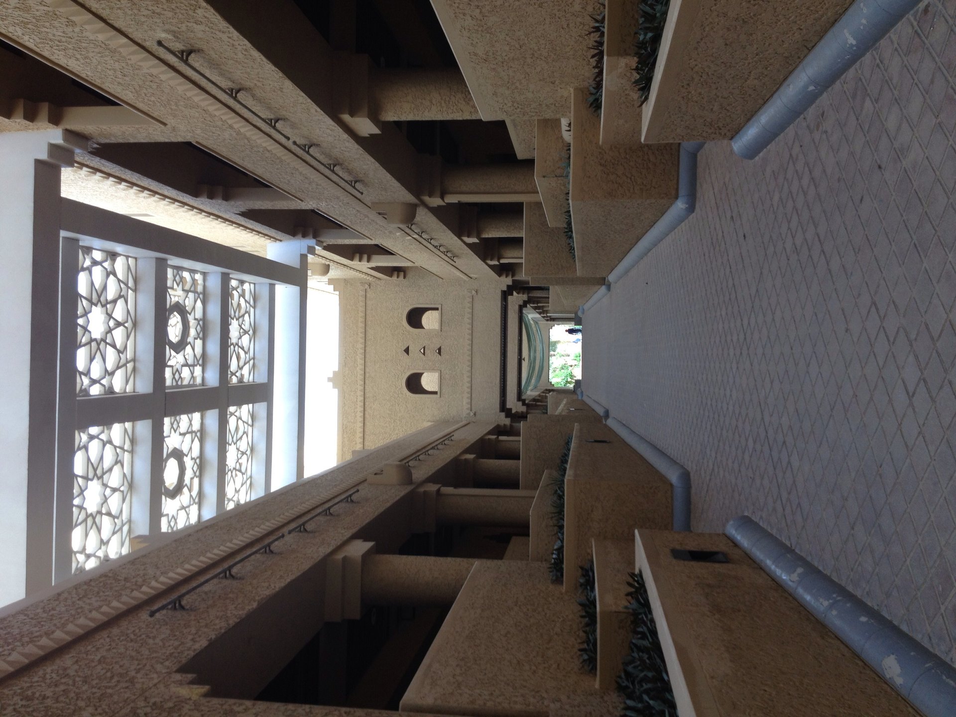 Covered arcade walkway in Al-Kindi Plaza, showing traditional Najdi geometric patterns and stonework in the Diplomatic Quarter