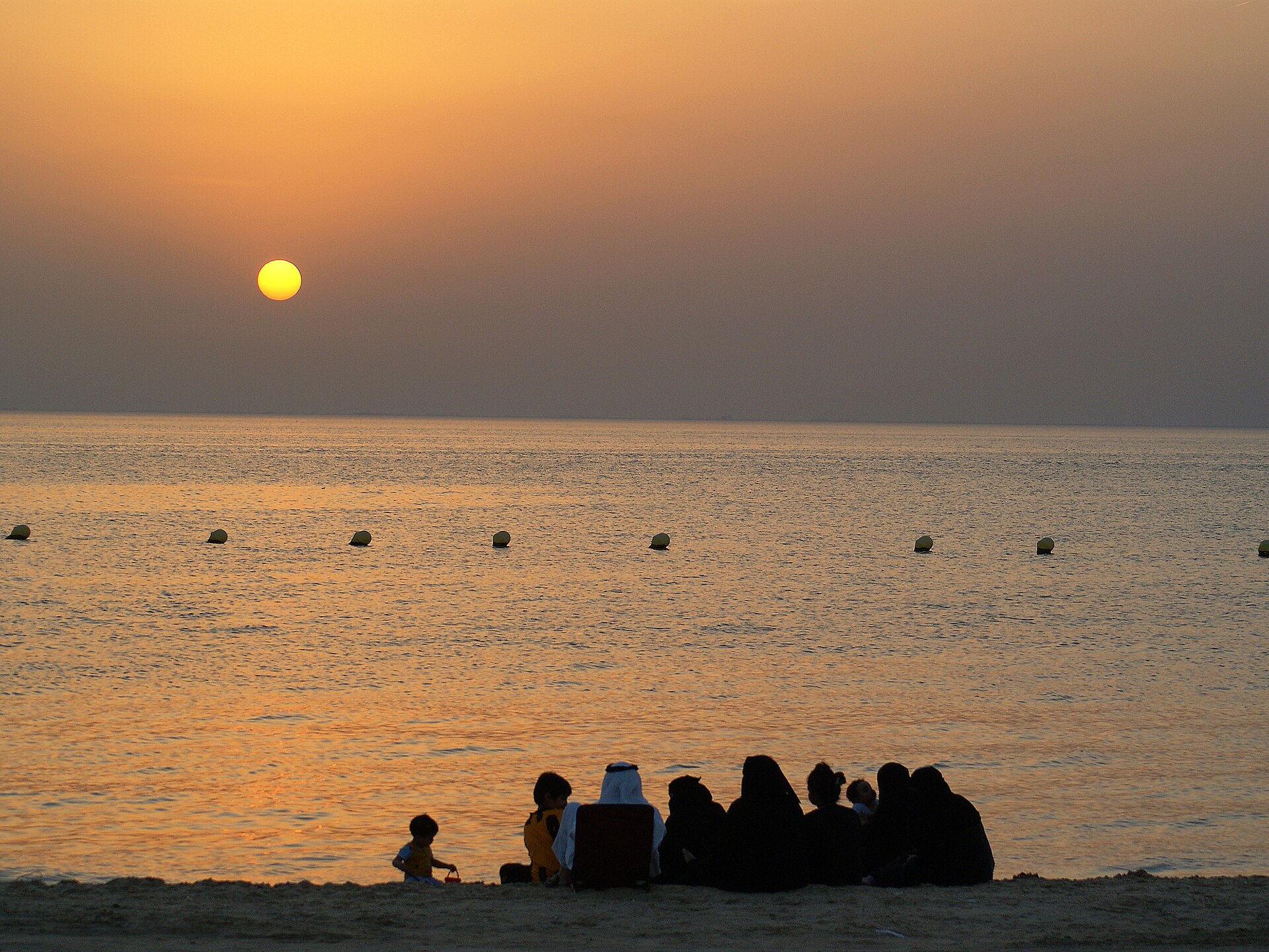 Saudi family watching the sunset at Half Moon Beach, Al Khobar, Eastern Province of Saudi Arabia