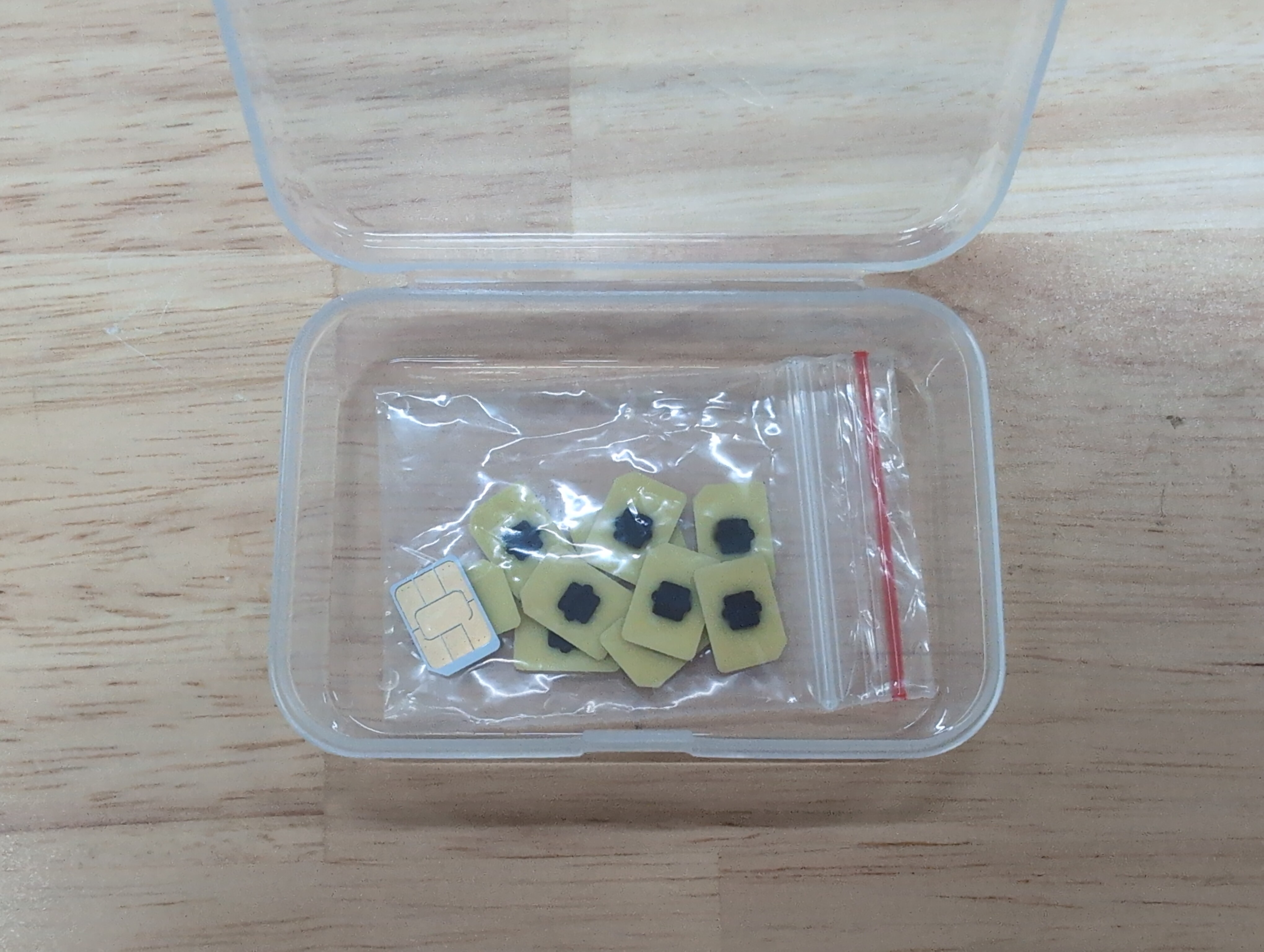 Close-up of eSIM eUICC chips extracted from an iPhone, mounted on 4FF nano-SIM carrier boards