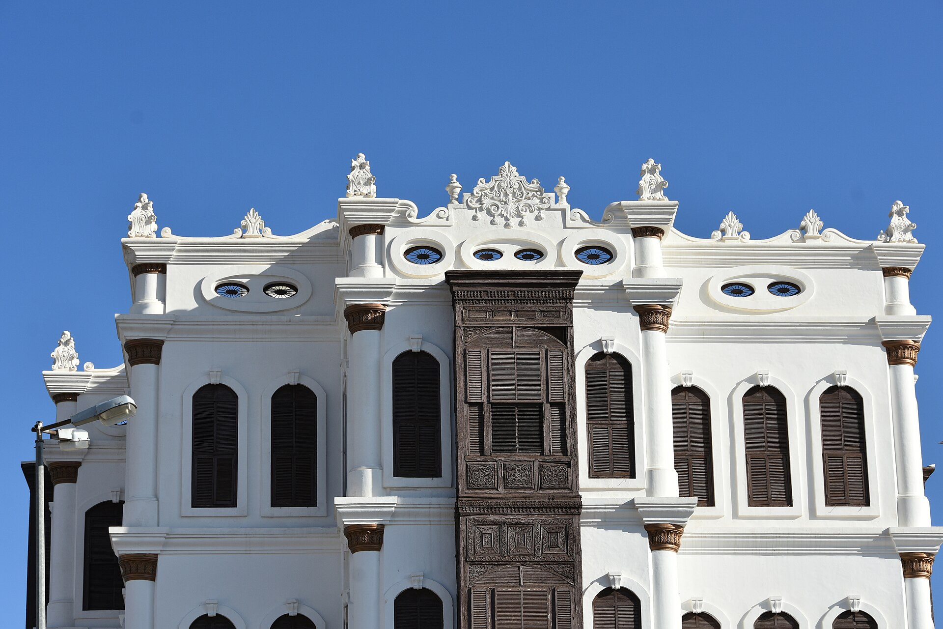 Shubra Palace in Taif with ornate white facade and wooden mashrabiya screens