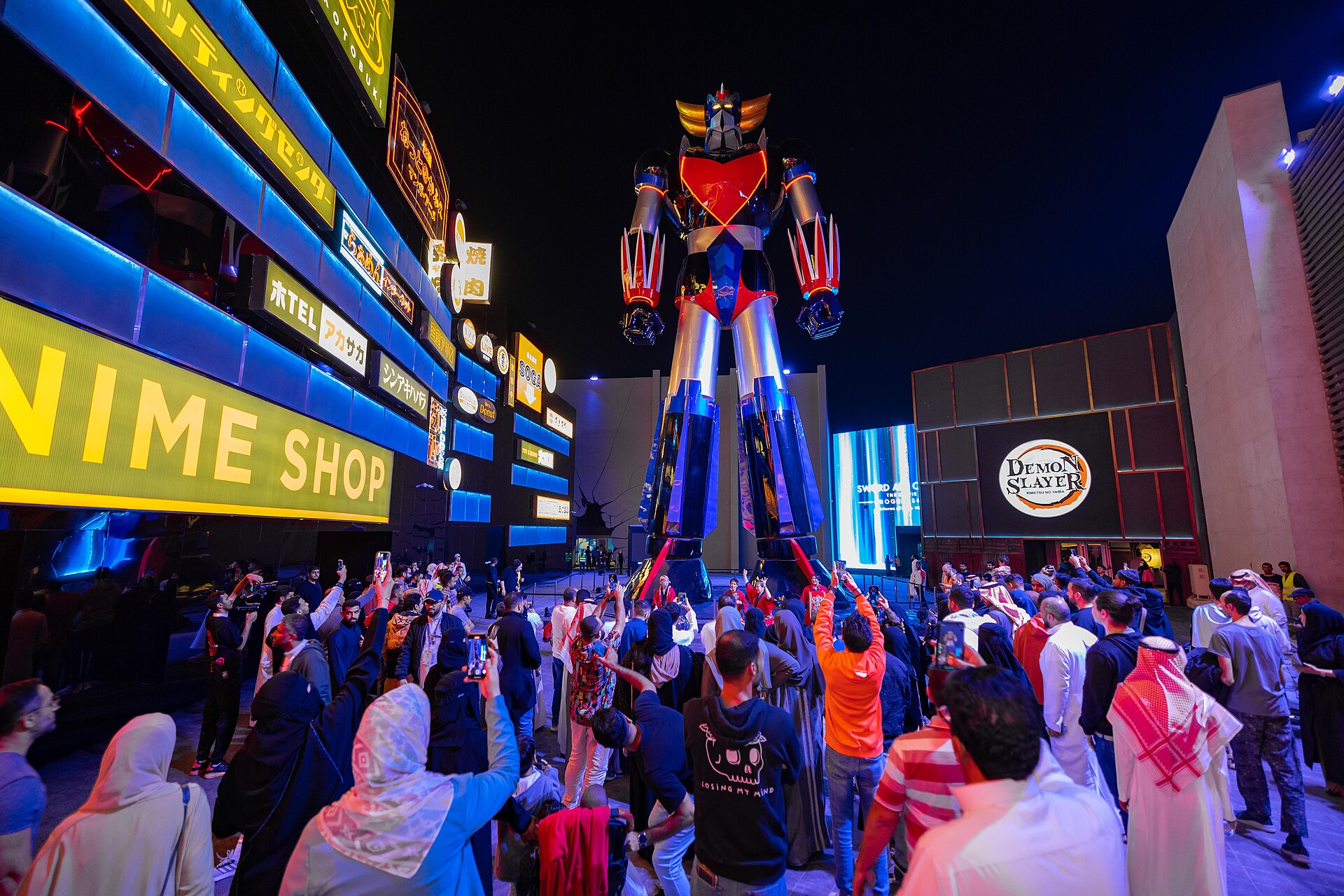 Giant Grendizer anime statue surrounded by crowds at Boulevard World during Riyadh Season