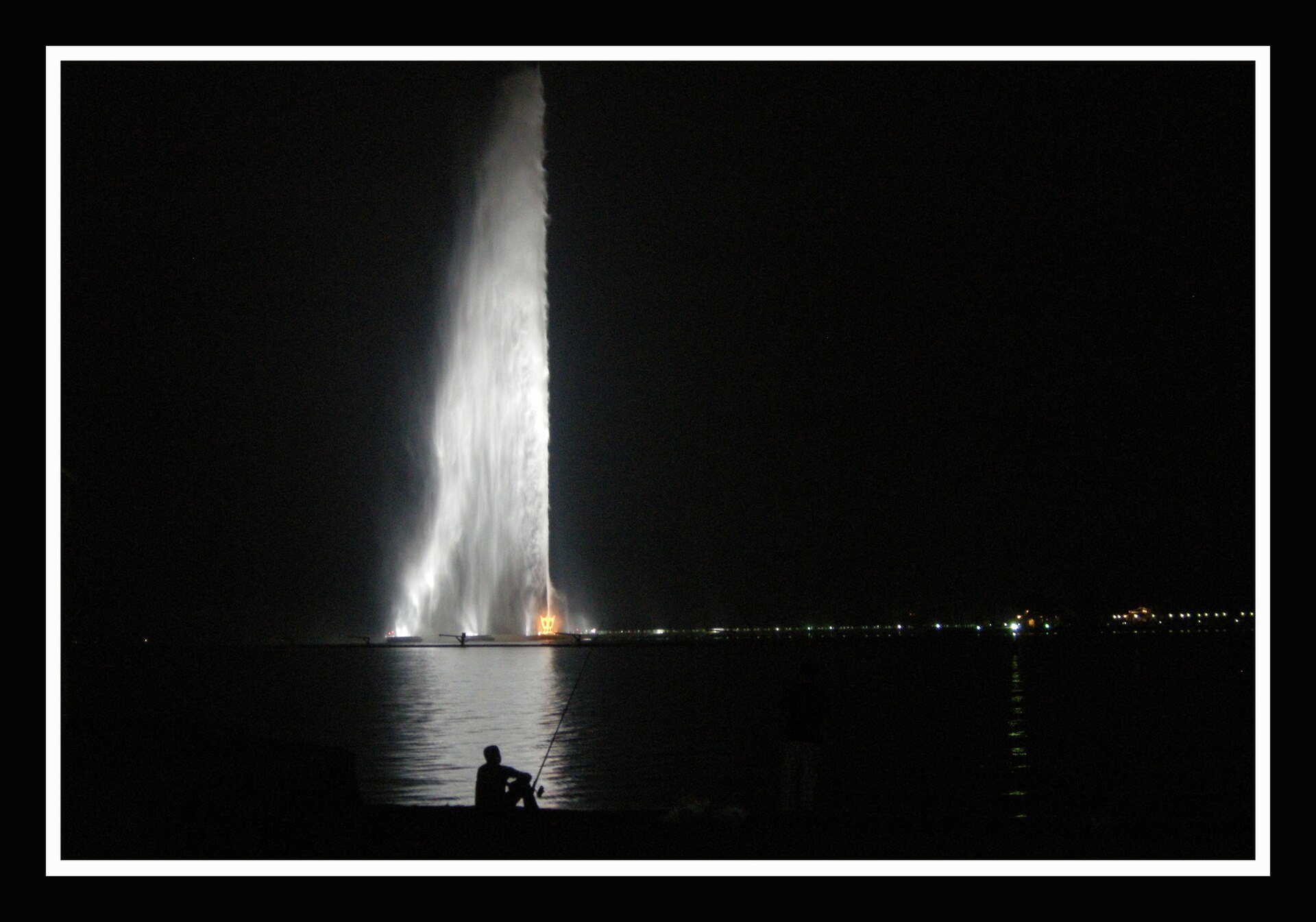 King Fahd Fountain illuminated at night over the Red Sea in Jeddah