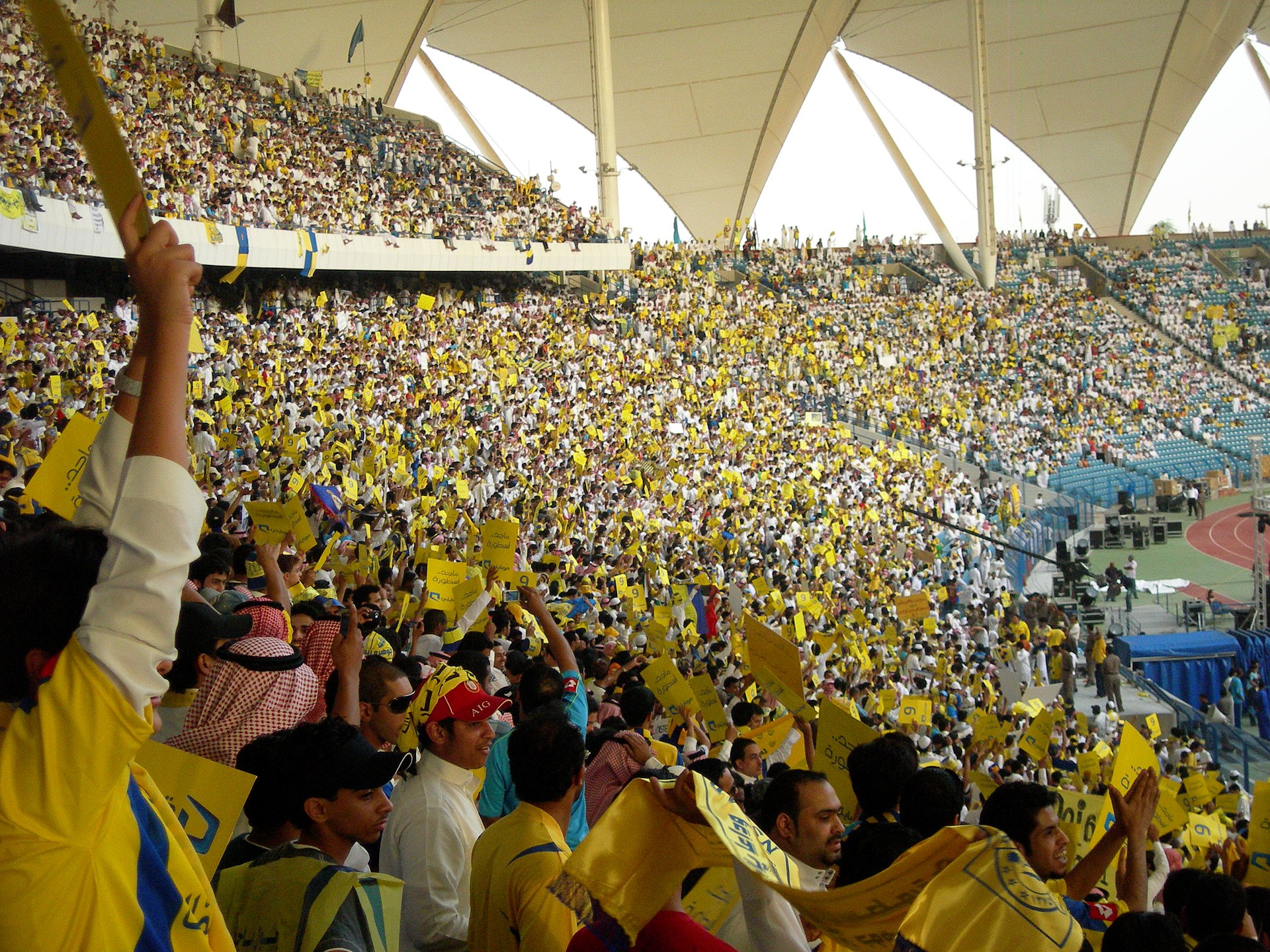 Thousands of fans in yellow shirts and flags packed into King Fahd International Stadium in Riyadh during a Saudi Pro League match