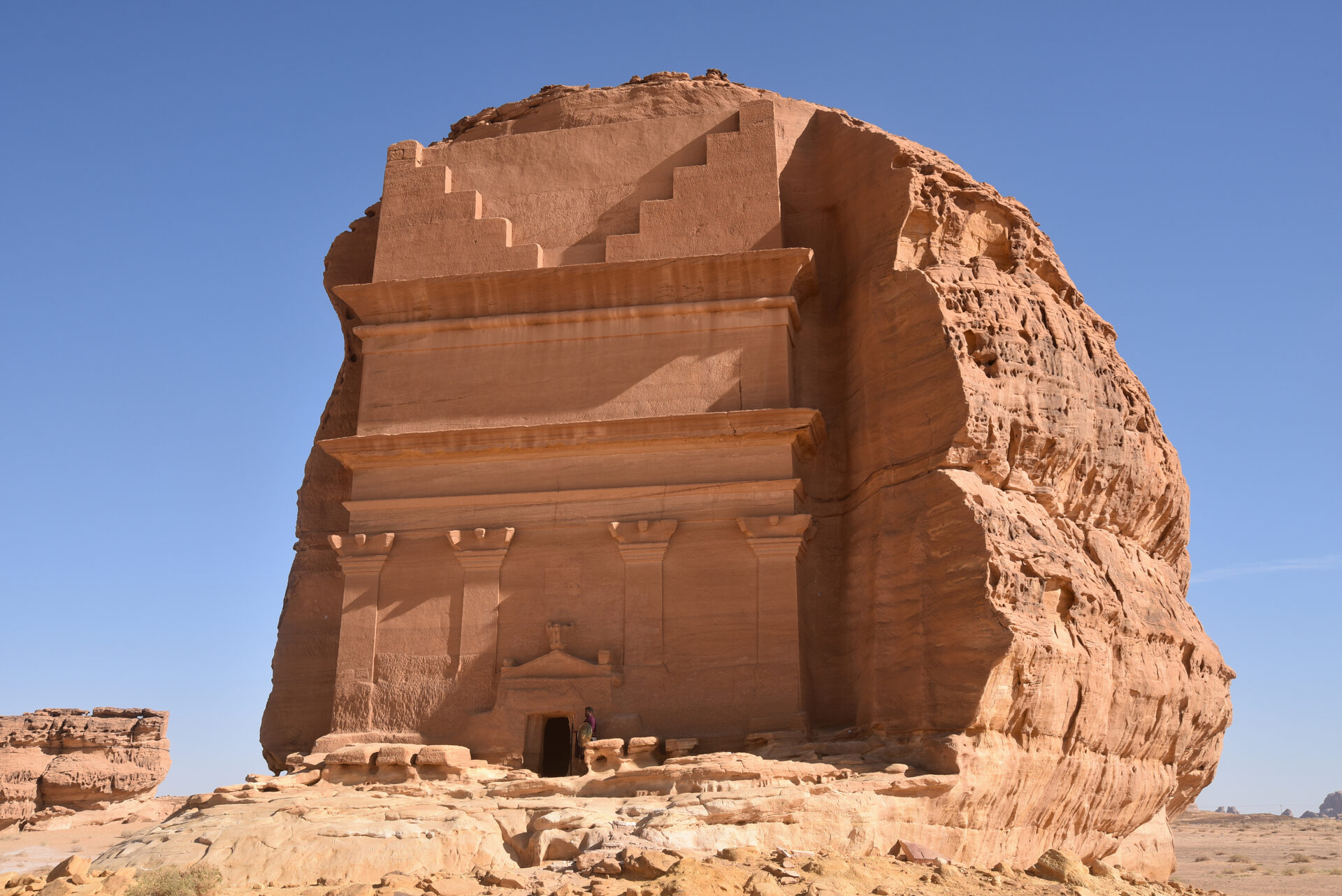Ancient Nabataean tomb facades carved into sandstone rock at Hegra, AlUla