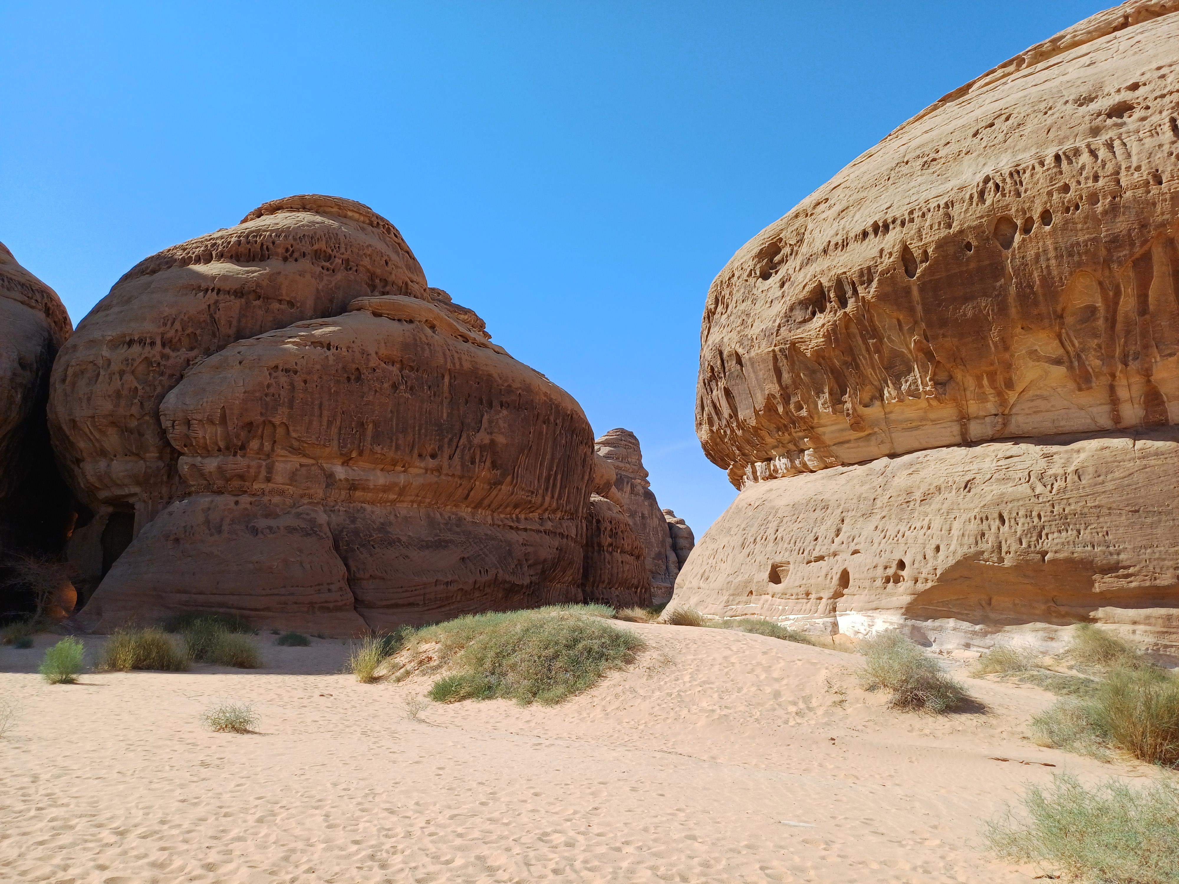 Sandstone rock formations in AlUla desert landscape with blue sky