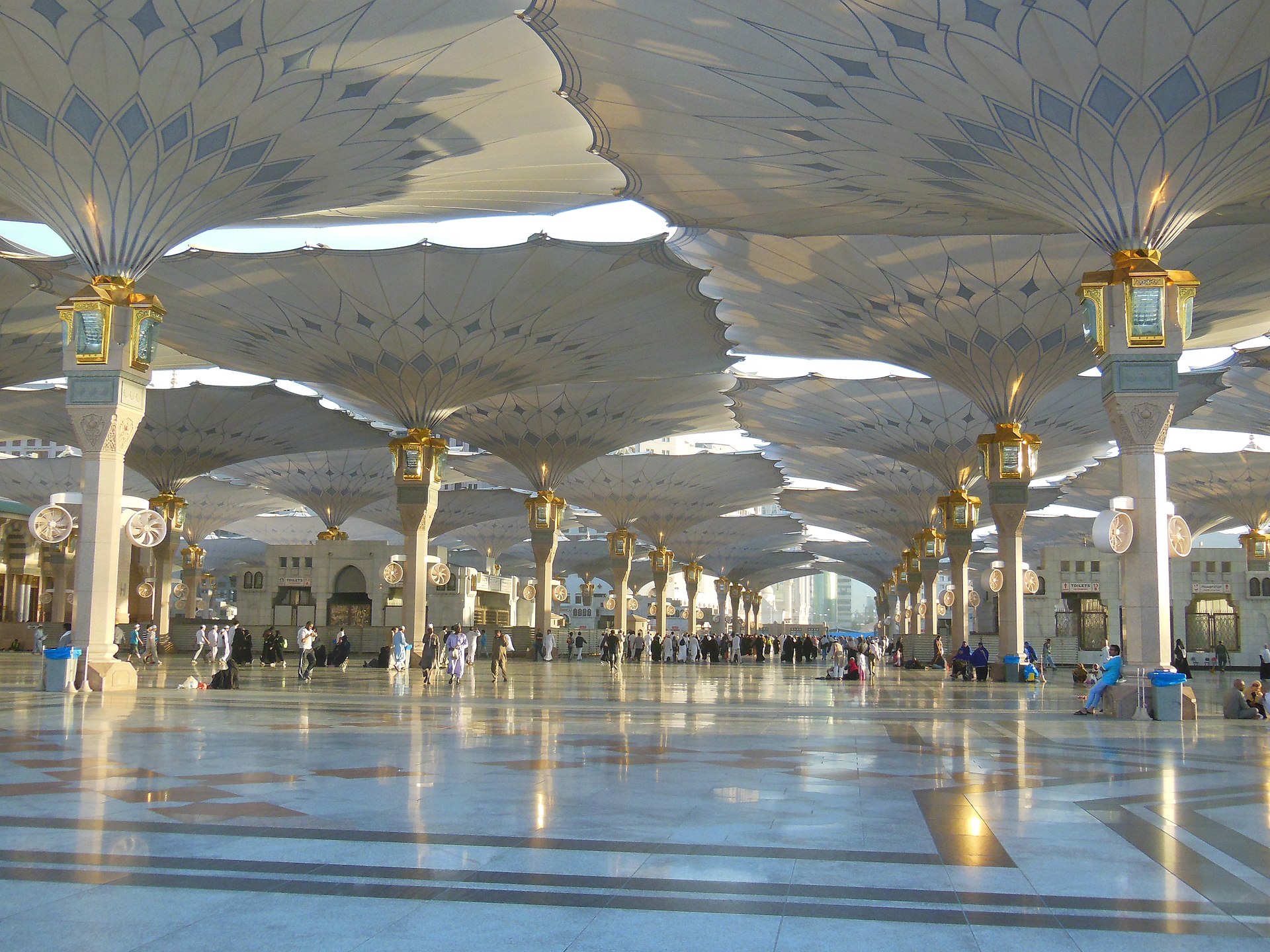 The iconic retractable umbrella canopies in the courtyard of Masjid al-Nabawi providing shade to worshippers