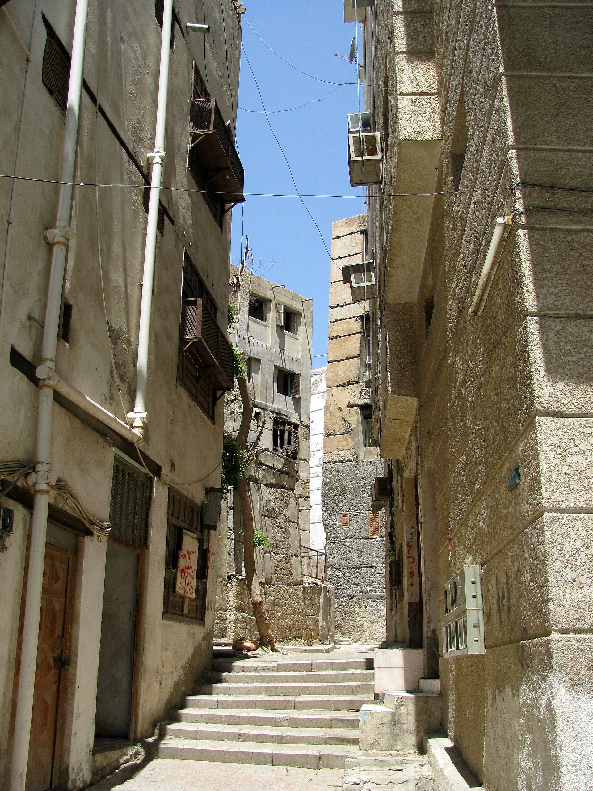 Narrow alleyway in Al Balad historic district Jeddah with traditional stone buildings and steps