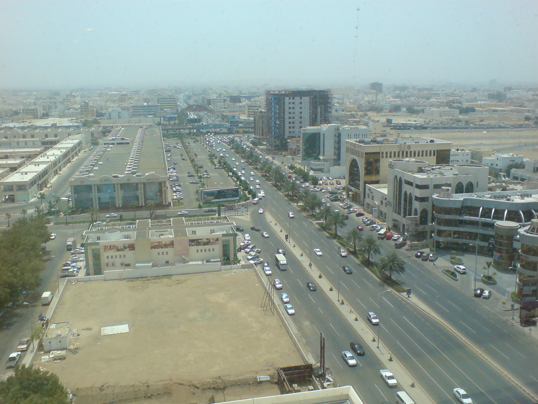 Aerial view of Tahlia Street in Jeddah showing the wide commercial boulevard lined with shops and boutiques
