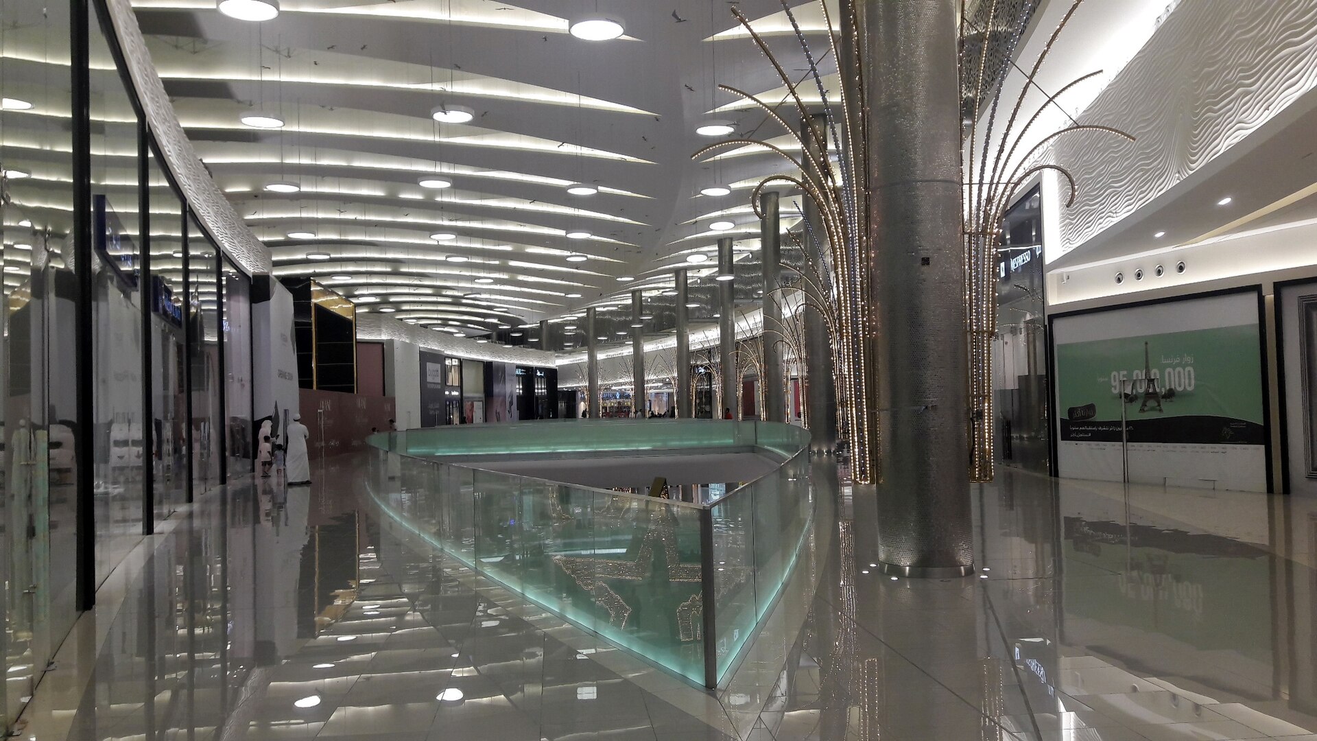 Interior of Mall of Arabia Jeddah showing polished floors, modern architecture, and decorative tree columns
