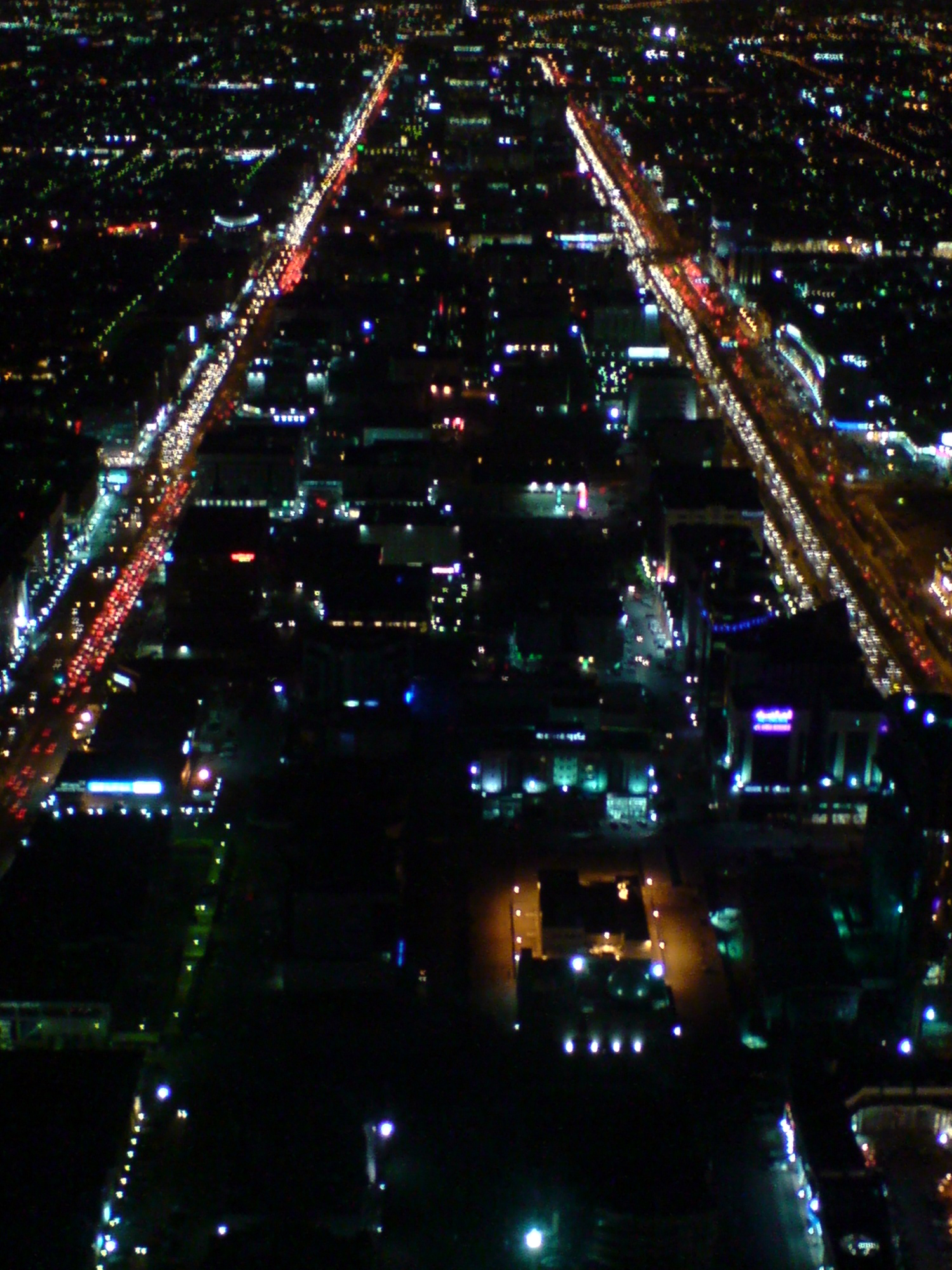 Night view looking down from Kingdom Centre Sky Bridge showing illuminated streets of Riyadh below