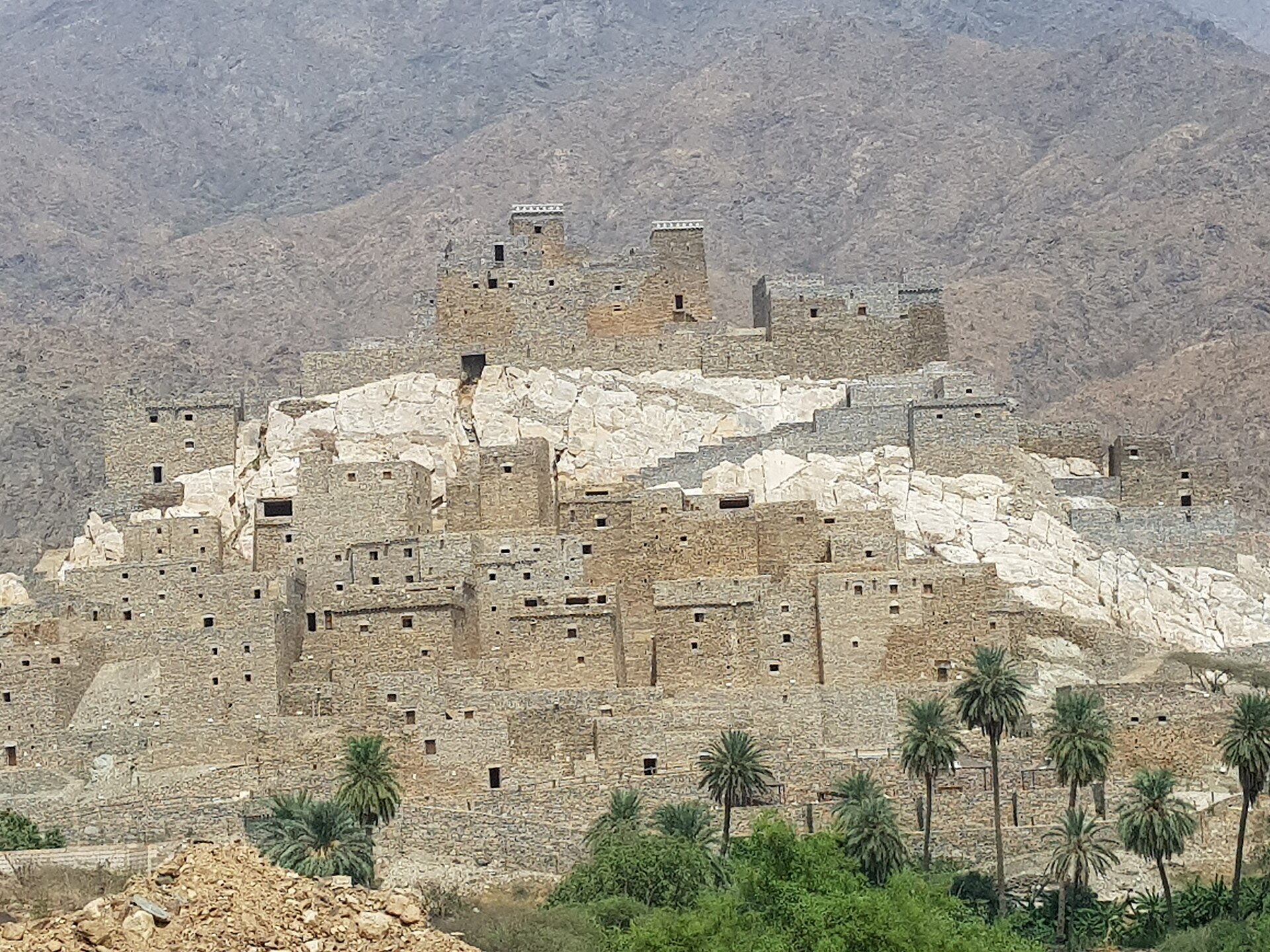 The stone buildings of Dhee Ayn marble village perched on a white marble hillside in Al Baha province, Saudi Arabia