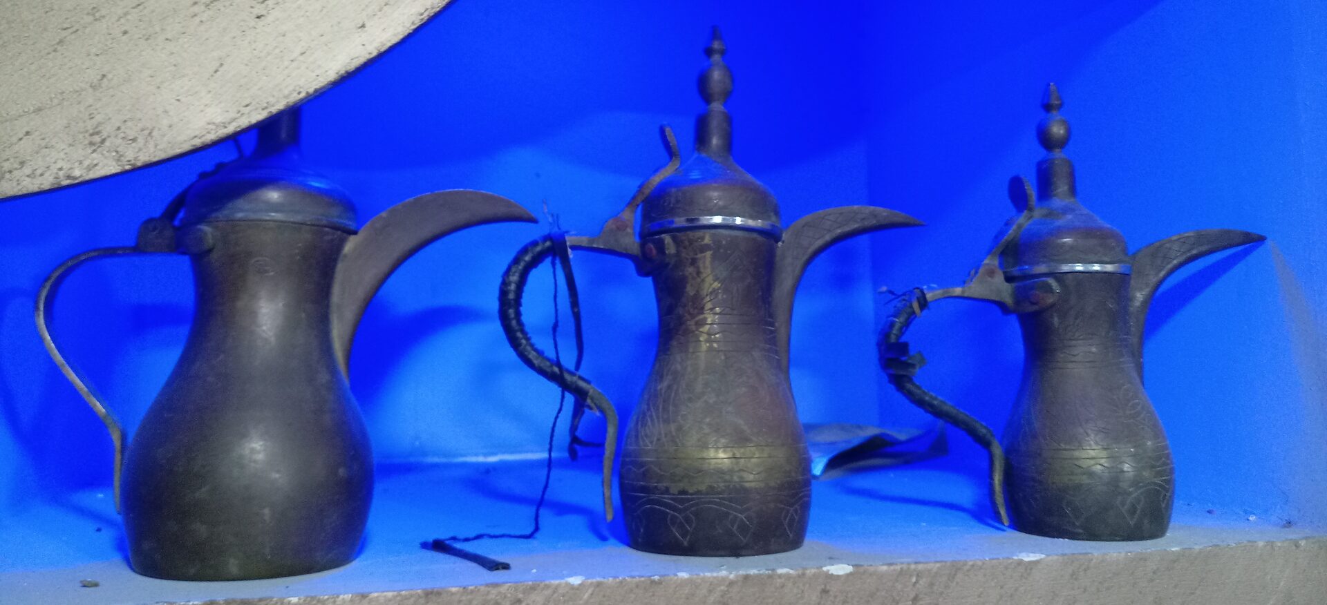 Traditional Arabic copper coffee pots (dallah) used for serving Saudi qahwa