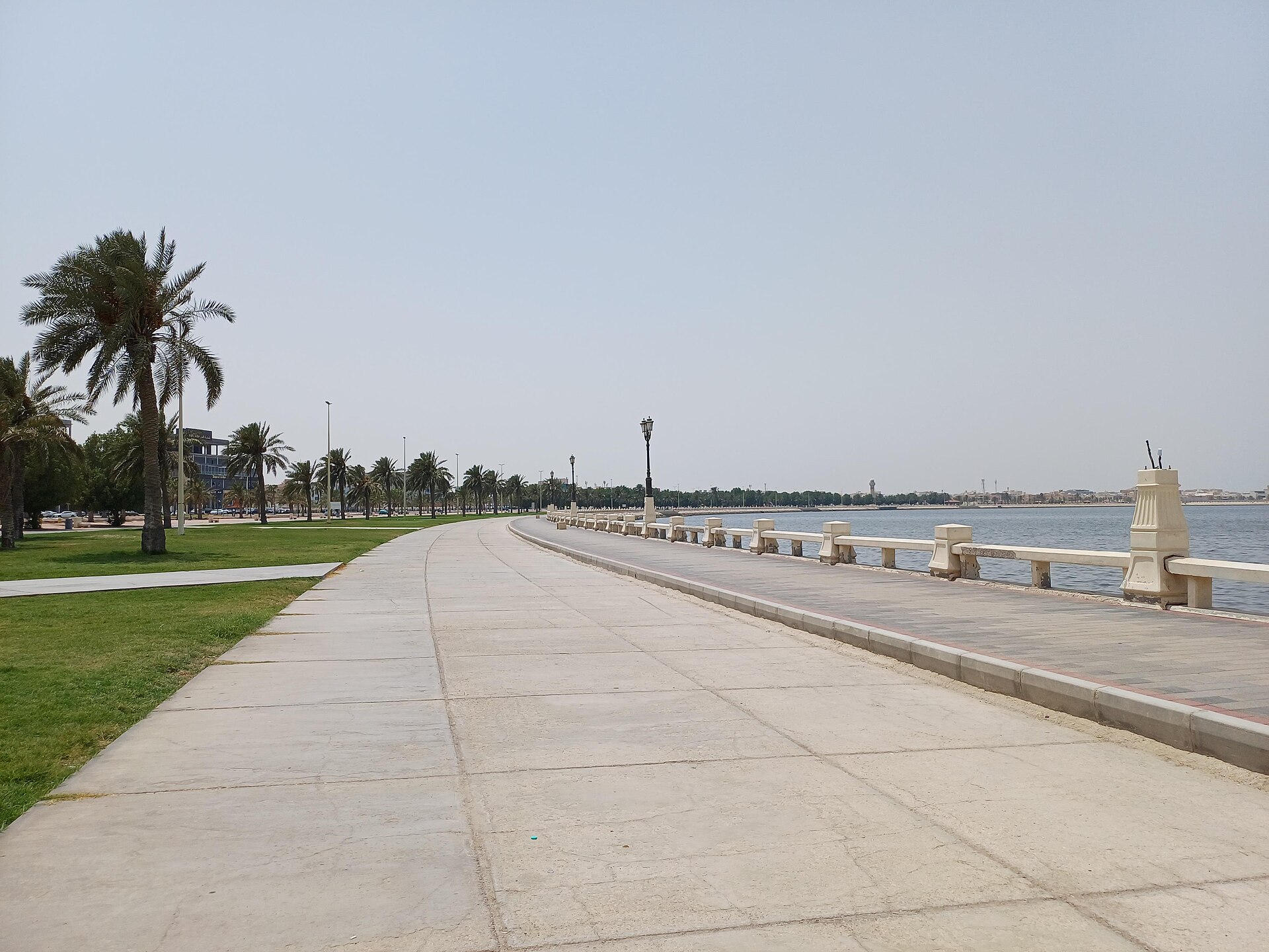 The Dammam Corniche waterfront promenade lined with palm trees along the Arabian Gulf