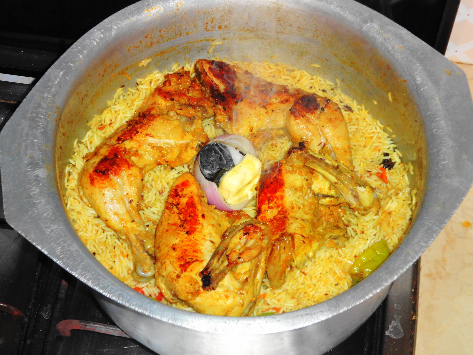 Chicken mandi rice cooking in a traditional pot — a popular Saudi-Yemeni dish