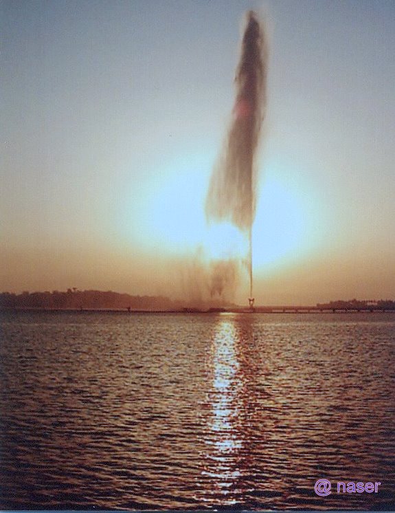 King Fahd's Fountain at sunset viewed from the Red Sea, with the water jet catching golden light