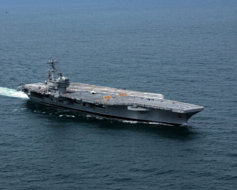 USS George H.W. Bush (CVN-77) underway at sea, aerial view showing the carrier’s flight deck and wake, deployed from Norfolk March 31 2026 as part of Carrier Strike Group 10