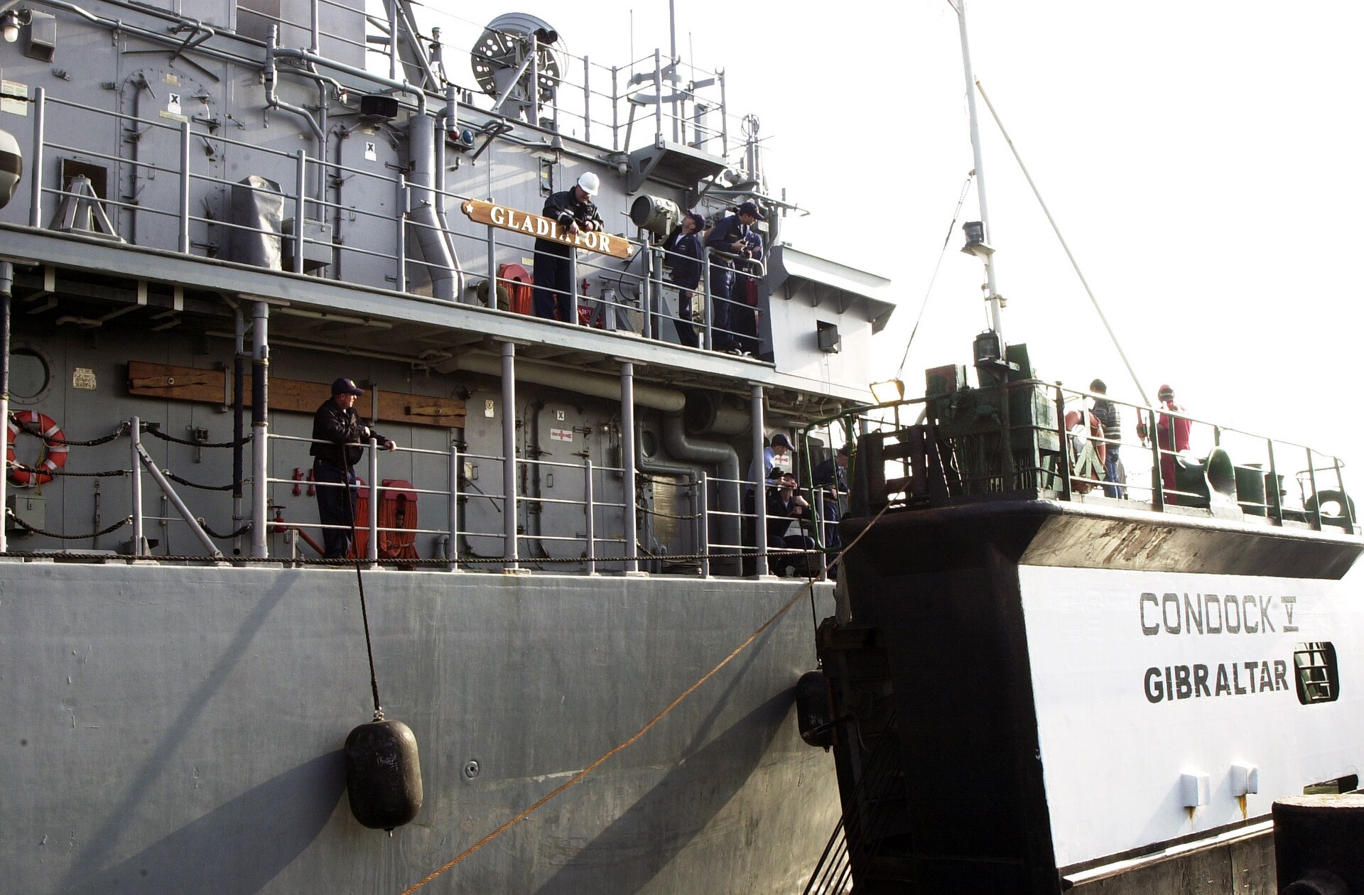 USS Gladiator MCM-11, an Avenger-class mine countermeasure ship with wooden hull, arriving at Naval Support Activity Bahrain