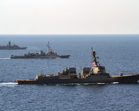 USS Halsey DDG-97 leads French frigate Jean de Vienne and Australian frigate HMAS Warrawunga in formation in the Arabian Gulf, March 2018 — the kind of multinational naval coalition absent from the April 2026 US blockade of Iranian ports