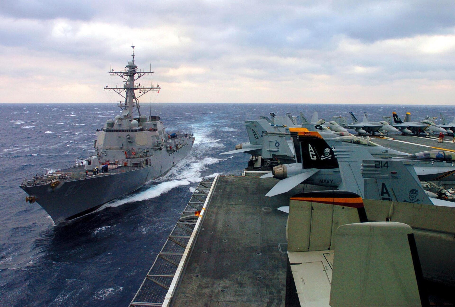 USS Mason (DDG-87), an Arleigh Burke-class guided-missile destroyer, makes way in the Atlantic alongside USS Dwight D. Eisenhower. Mason is one of the destroyers assigned to enforce Operation Epic Fury maritime interdiction.