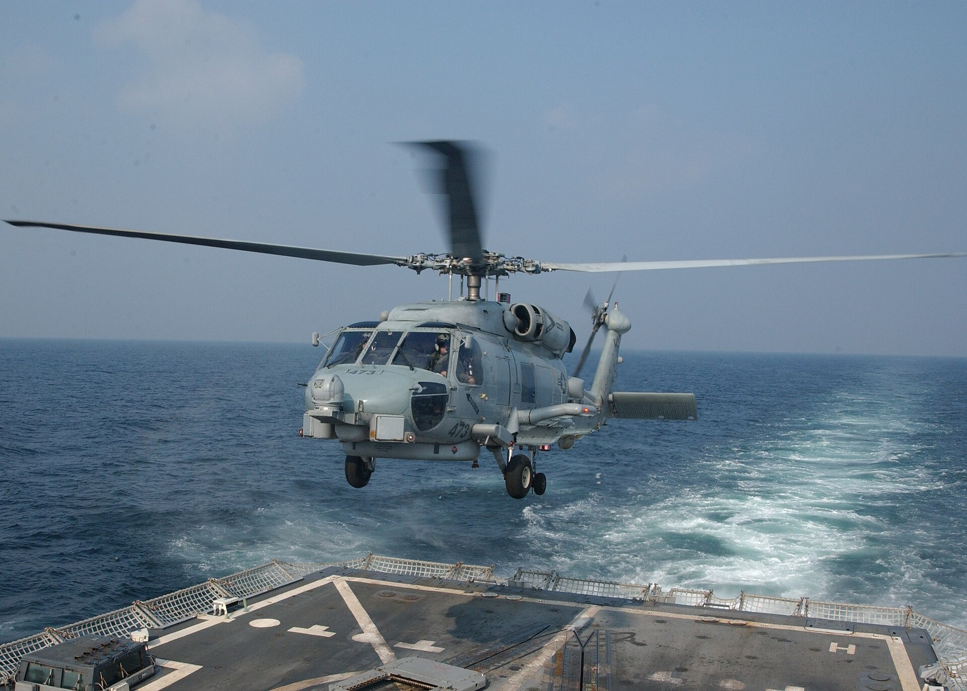 SH-60B Seahawk helicopter launching from USS Mason DDG 87 on aerial security patrol over the Central Persian Gulf — the type of US Navy presence enforcing the April 13 blockade that Ghalibaf named as the precondition for reopening Hormuz