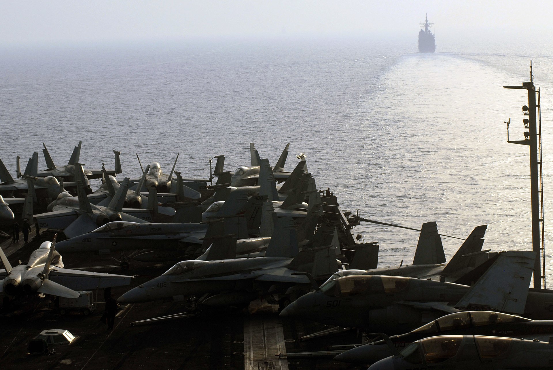USS Nimitz carrier strike group transits the Strait of Hormuz with F/A-18 aircraft on deck and USS Princeton ahead, July 2007