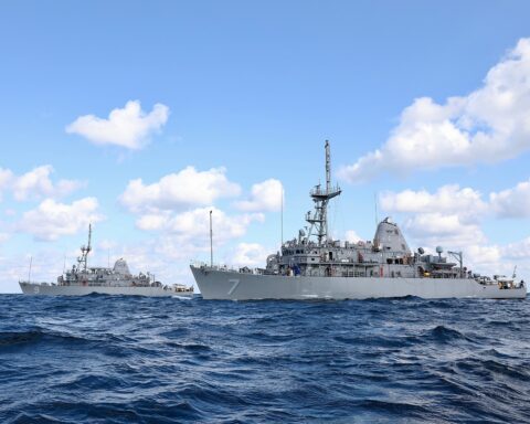 USS Pioneer (MCM-9) and USS Patriot (MCM-7) Avenger-class minesweepers underway in open ocean, US Navy