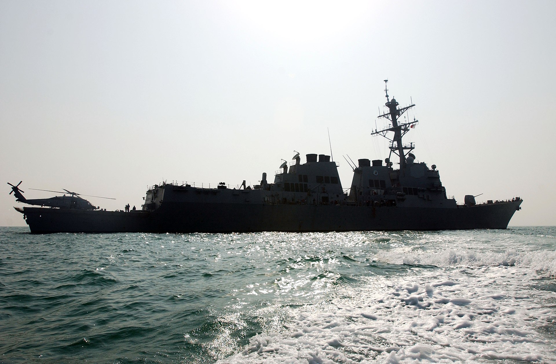 USS Oscar Austin (DDG-79), an Arleigh Burke-class guided-missile destroyer, under way in the Persian Gulf — the same class targeted by IRGC drone strikes on April 20, 2026