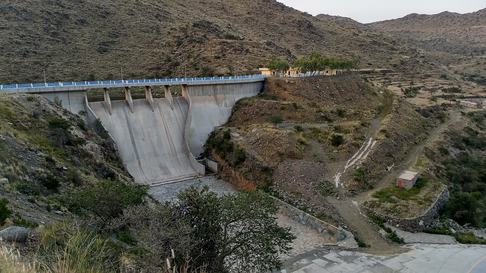 Valley Ashran Dam surrounded by green mountain slopes near Abha, Saudi Arabia