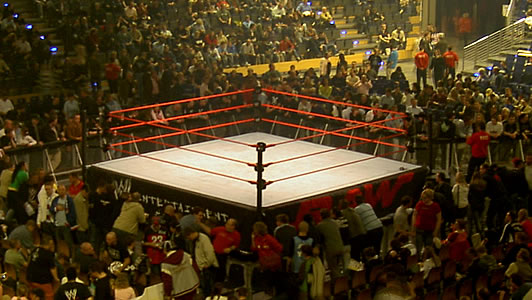 WWE wrestling ring set up for a live event with fans in the arena