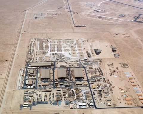 Al Udeid Air Base aerial view showing runway aprons and hangar complex, Qatar