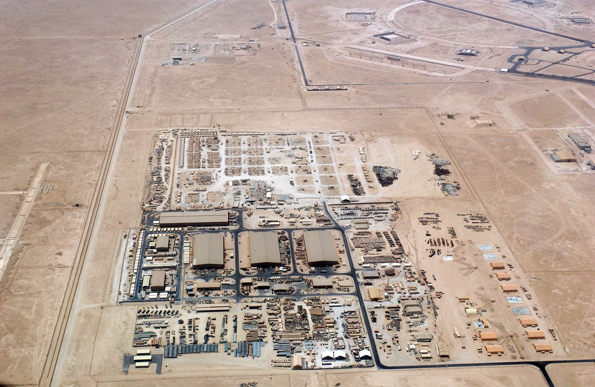Aerial photograph of Al Udeid Air Base, Qatar — forward headquarters of US Central Command hosting approximately 10,000 US personnel