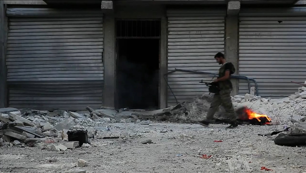 A fighter walks through rubble in Aleppo during the Syrian civil war, with destroyed storefronts and debris in the foreground