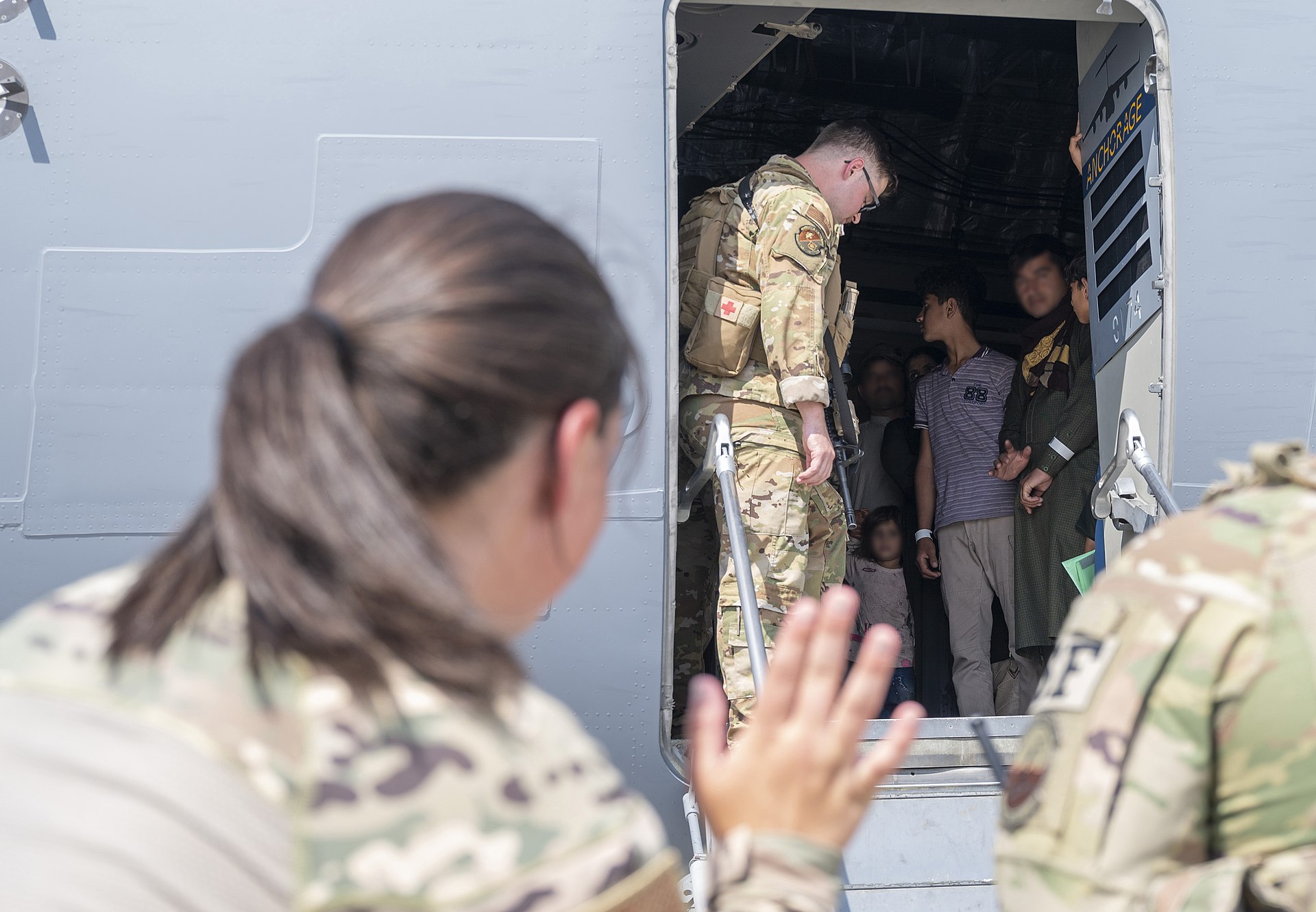 Afghan evacuees arrive aboard a C-17 at Ali Al Salem Air Base, Kuwait, in August 2021 — the 386th Air Expeditionary Wing hub that has been repeatedly targeted by Iranian missiles since February 2026