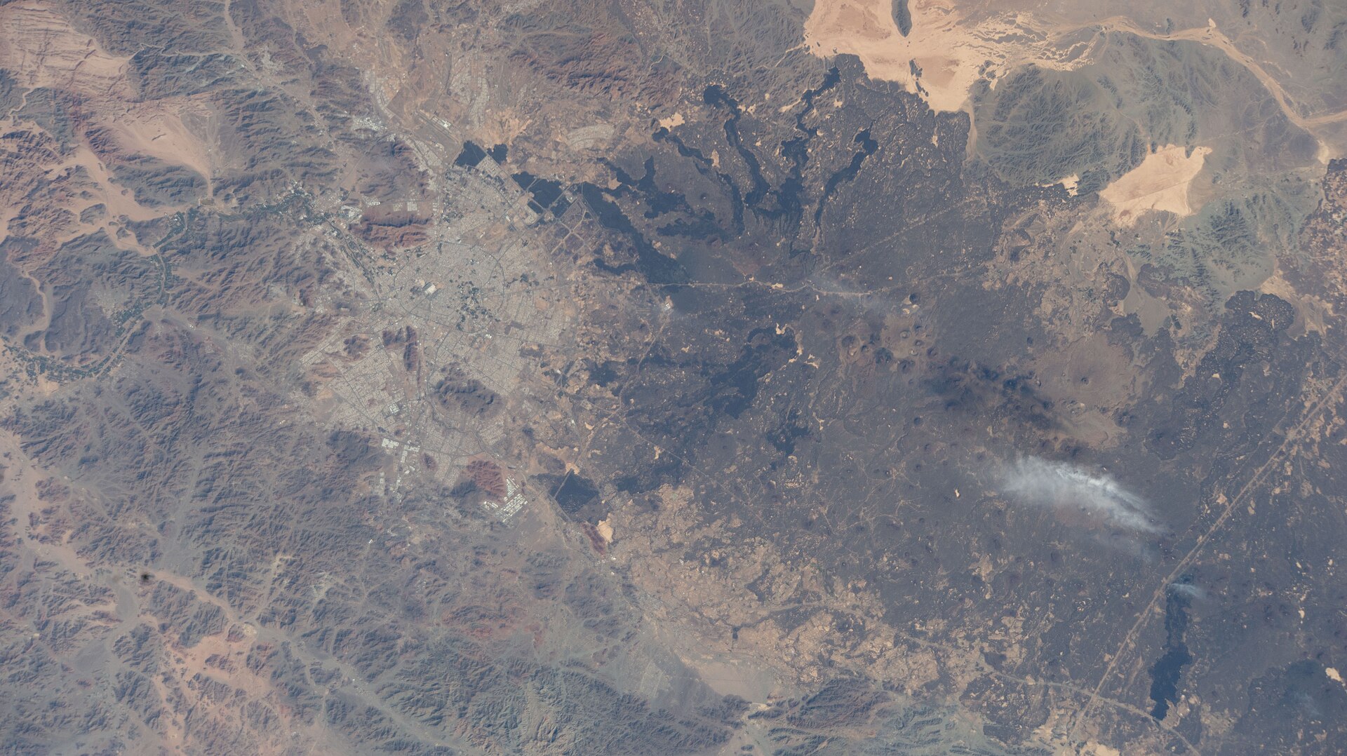 Madinah Saudi Arabia and the Arabian Shield volcanic fields photographed from the International Space Station — the 540-million-year-old geological formation holds an estimated 90,000 tonnes of uranium reserves