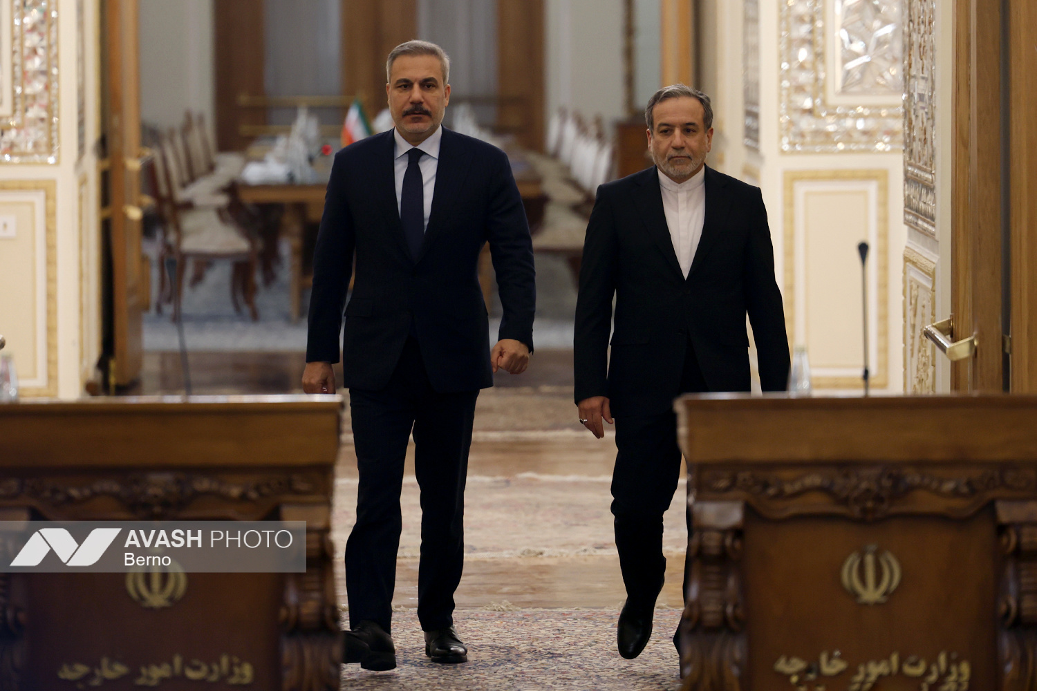 Iranian Foreign Minister Abbas Araghchi and Turkish Foreign Minister Hakan Fidan walking toward negotiation table at Iranian Ministry of Foreign Affairs, Tehran, November 2025