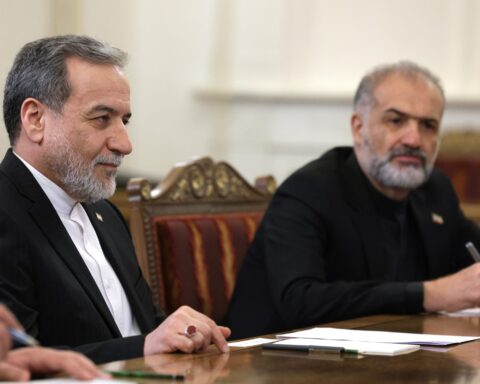 Abbas Araghchi, Iran foreign minister, seated at diplomatic negotiating table with Iranian delegation during high-level talks, 2025
