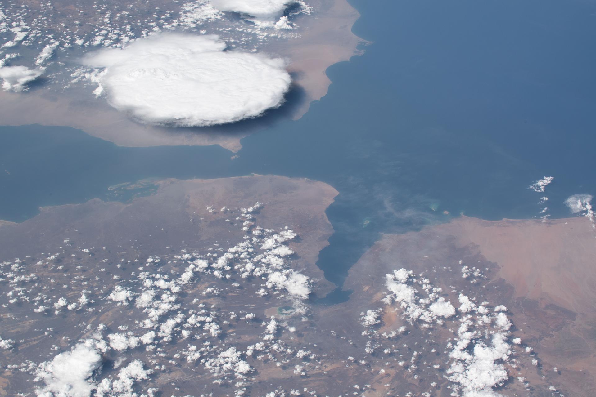 The Bab al-Mandab Strait photographed from the ISS on May 29, 2019. The narrow passage between Yemen (lower) and Djibouti and Eritrea (left) is the chokepoint through which Oxagon green ammonia exports bound for Asia must transit. Houthi attacks on Red Sea shipping since 2024 have demonstrated Iran-aligned forces can reach these waters. Photo: NASA/ISS Expedition 59, public domain