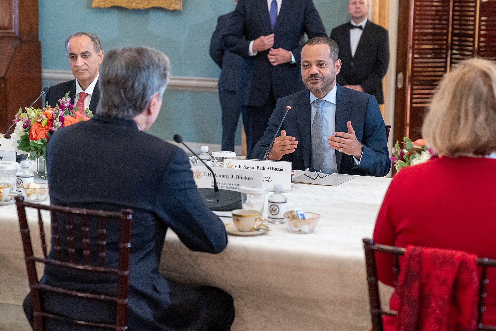 Omani Foreign Minister Badr al-Busaidi chairs talks across the diplomatic table — Oman serves as messenger-shuttle for US-Iran nuclear negotiations, hosting all four rounds