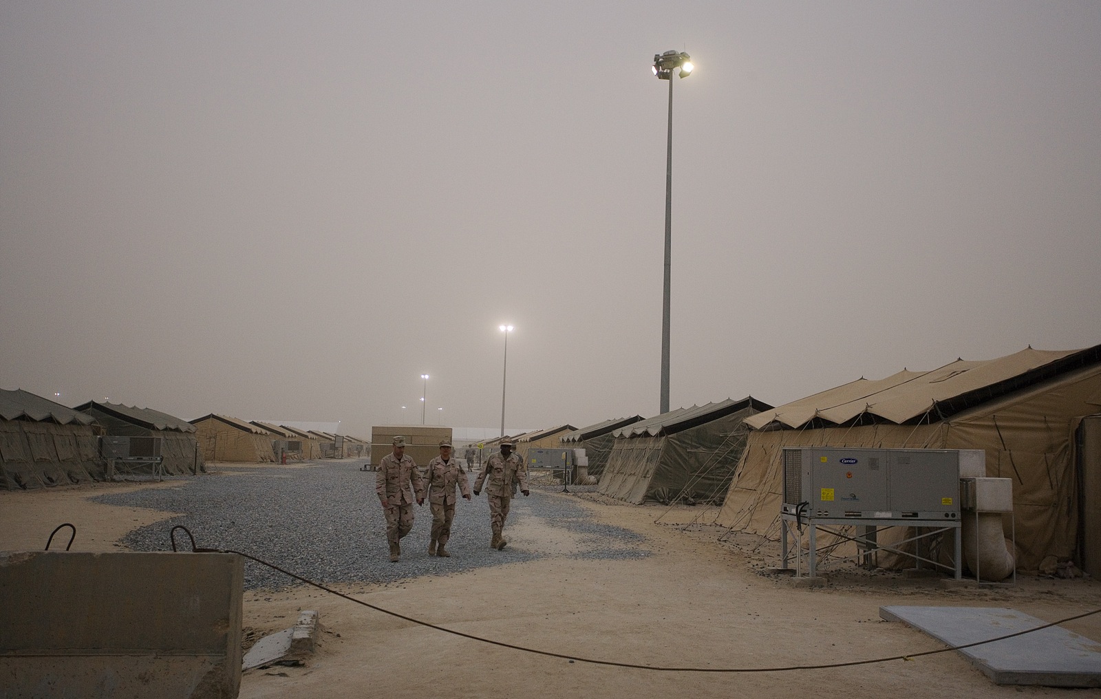 A guard tower and Black Hawk helicopter at Camp Buehring (Al-Udairi), Kuwait, the largest concentration of US forces in the Gulf region with approximately 13,500 troops