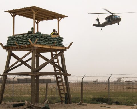 US Army soldiers walk through Camp Buehring, Kuwait, a forward operating base in the northern desert used as a staging point for CENTCOM helicopter operations