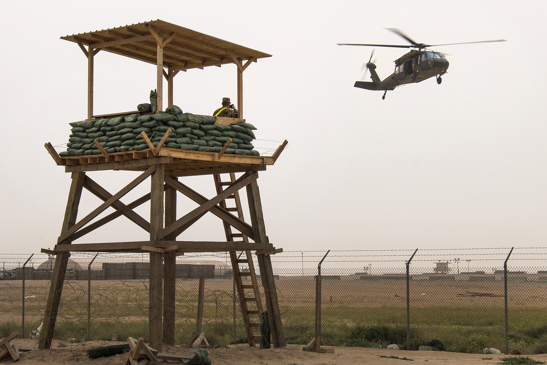 US Army soldiers walk through Camp Buehring, Kuwait, a forward operating base in the northern desert used as a staging point for CENTCOM helicopter operations