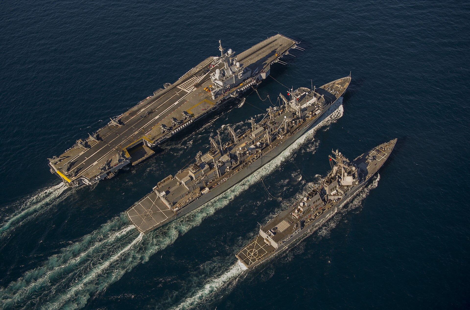 French aircraft carrier Charles de Gaulle (R91) conducting underway replenishment with USS Bulkeley and USNS Arctic in the Gulf of Oman, December 2013